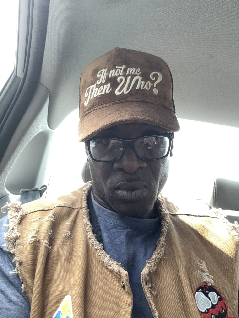 Brown If Not Me Then Who hat worn with a vest