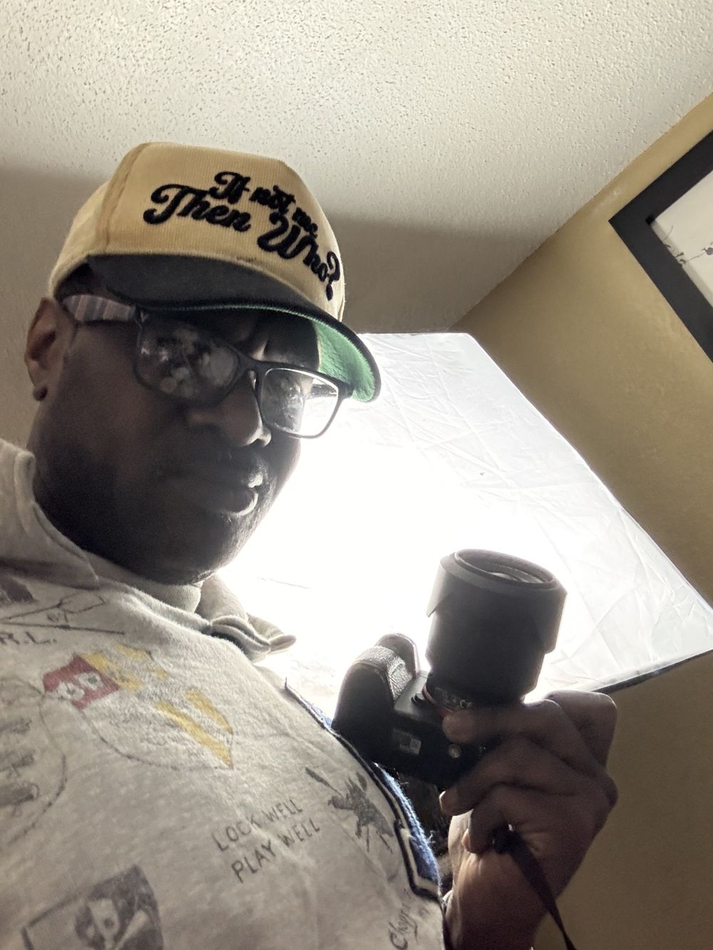 Cream and black corduroy If Not Me Then Who hat worn by the photographer